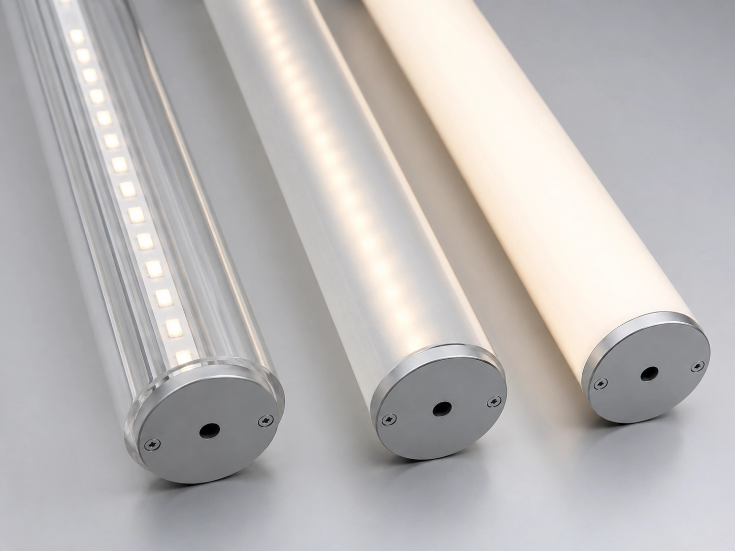 Comparison of clear, frosted, and opal round acrylic tubes for LED lighting applications showing different haze levels Comparison of clear, frosted, and opal round acrylic tubes for LED lighting applications showing different haze levels